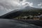 The volcano of stromboli seen from the harbor with covering clouds