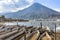 Volcano & traditional boats by lakeside, Santiago Atitlan, Lake Atitlan, Guatemala