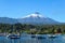 Volcano Villarica and boats in lake