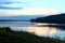 Volga river and forest on blue sky background. Sunset. Horizontal view.