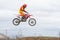 Volgograd, Russia - April 19, 2015: Motorcycle racer jumping on the trampoline in flight, at the stage of the Open Championship Mo