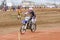 Volgograd, Russia - April 19, 2015: Motorcycle racer racing on the track, the spectators in the background, at the stage of the Op