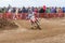 Volgograd, Russia - April 19, 2015: Motorcycle racer rides on the turn track, the spectators in the background, at the stage of th