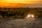 VOLKOVO, RUSSIA - OCTOBER 10, 2020: Blue Nissan Qashqai climbing up on dirt road at autumn golden sunset offroad.