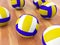 Volleyball balls on parquet floor