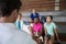 Volleyball coach discussing over clipboard with female player