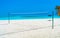 Volleyball net on a deserted sandy beach on the tropical sea.