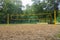 A volleyball net hang over the sand field