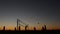 Volleyball net silhouette on beach court at sunset, players on California coast.