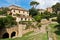 Volterra cityscape inside city walls, vintage houses on a hill surounded by pine and cypress trees, Tuscany