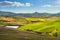 Volterra panorama, rolling hills, green fields and small lake. Tuscany, Italy