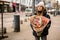 Voluminous bouquet of flowers in the hands of a cute girl in a black jacket