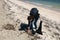 Volunteer collecting garbage on beach