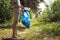 A volunteer and eco activist collects garbage in bags, in the forest, close-up. Recycling of plastic waste, environmental