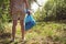 A volunteer and eco activist collects garbage in bags, in the forest, close-up. Recycling of plastic waste, environmental