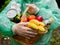 Volunteer food delivery in any weather concept. Portrait of a basket of food in the hands of a woman volunteer in