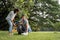 Volunteer lovers couple wearing gloves walking to collect rubbish in the park