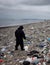 Volunteer picking up trash on the beach. World Earth Day. Generative Artificial Intelligence