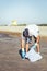 Volunteer picking up waste that pollute the ocean
