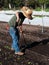 Volunteer preparing soil at community farm