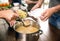 Volunteer serving food to poor people in charity centre