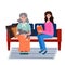 Volunteer takes care elderly woman. Social worker reads book old woman. Smiling young Lady sits in the sofa with grandma