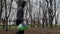 A volunteer walks down the street with a package of collected garbage and waste.