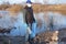 A volunteer wearing a protective mask collects empty bottles. The concept of ecology and environmental protection