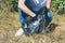 Volunteer woman clean on collects garbage plastic trash bottle in bag rubbish