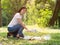 Volunteer women collect plastic water bottles in the park area, From people who refuse to throw in the trash