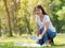 Volunteer women collect plastic water bottles in the park area, From people who refuse to throw in the trash