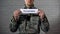 Volunteer word written on sign in hands of male soldier, man joins armed forces