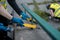 volunteer worker painting and renovate railing or fence in public park