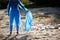 volunteering, charity, cleaning, people and ecology concept, volunteer with garbage bag cleaning area on the beach