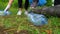 Volunteers collecting bottles in the forest.