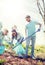 Volunteers with garbage bags cleaning park area