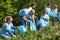 Volunteers with garbage bags cleaning park area