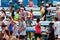 Volunteers Hand Out Water Bottles To Exhausted Runners After Race