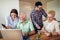 Volunteers help senior people on the computer. Young people giving senior people introduction to internet