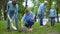 Volunteers planting tree saplings in park, natural resources conservation, care