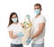 Volunteers in protective masks and gloves with products on background. Aid during coronavirus quarantine