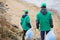 Volunteers walking to polluted shore