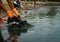 Volunteers wear orange rubber gloves to collect garbage on the beach. Beach environment pollution. Volunteers cleaning the sand.