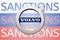 Volvo logo in front of the sanction text on the Russian flag. Fresh sanctions against Russia over its invasion of