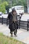 Voronezh, Russia - Circa 2014: Homeless sad old man walking along street