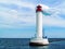 Vorontsov lighthouse in Odessa against the background of the Black Sea, close-up. White tower with a red cabin at the top on a