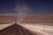 Vortex in the horizon of endless dirt road through waste barren plane in Atacama desert, Chile