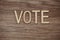 Vote Alphabet Letters on wooden background