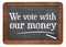 We vote with our money blackboard sign