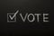 Vote tick on chalkboard, black background, elections 2020